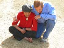 Marko comforts a village boy whose father died only minutes before